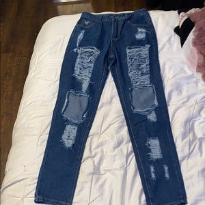 dark blue , ripped jeans .